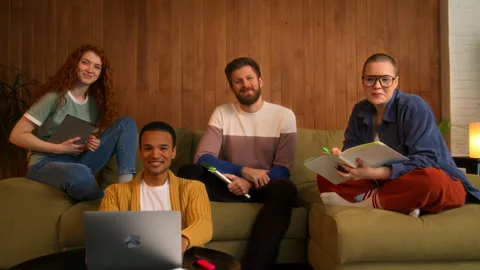 Portrait of students group sitting on sofa indoors Stock Footage 267829850