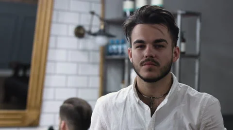 Portrait of stylish barber. Professional filmed on video, while working in his Stock Footage