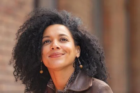 Portrait of stylish brooding young African American woman focused thinking about Stock Photos