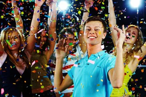 Portrait of stylish guy dancing on background of energetic friends Stock Photos