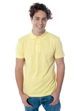 Portrait of a stylish guy standing with hands in pockets Stock Photos