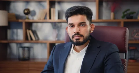 Portrait of stylish happy smiling bearded indian business man looking at camera Stock Footage 220135879