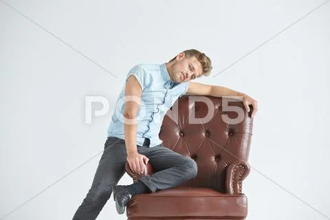Portrait of a stylish intelligent man, small unshaven, charismatic, blue shir Stock Photos