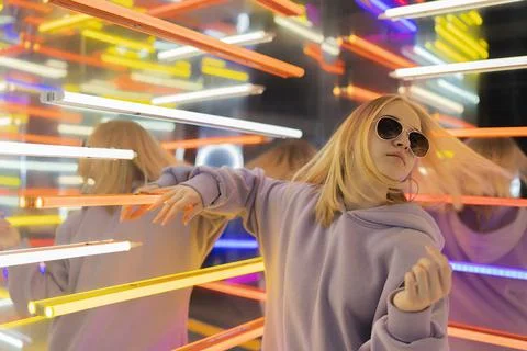 Portrait of a stylish teenage girl in a neon room. Stock Photos
