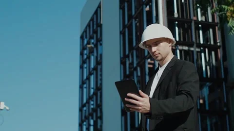Portrait of a successful handsome engineer, architect, builder, businessman in a Stock Footage 249263068