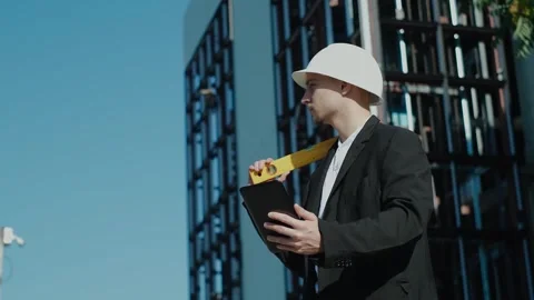 Portrait of a successful handsome engineer, architect, builder, businessman in a Vidéo 249263070