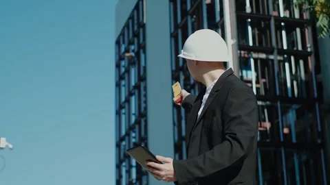 Portrait of a successful handsome engineer, architect, builder, businessman in a Stock Footage 249263085