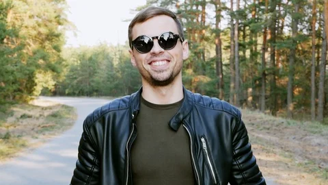 Portrait of a successful man looking into the camera, nods his head and smiling Stock Footage 106684030