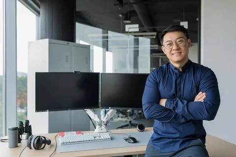 Portrait of successful programmer in modern office of development company, asian 写真素材