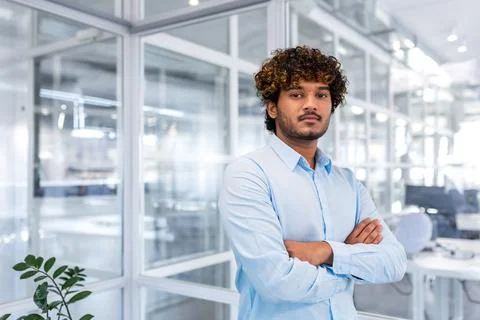 Portrait of a successful young hispanic programmer standing in a modern office Stock Photos