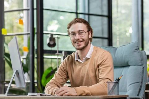 Portrait of a successful young man, programmer, IT developer, software sitting Stock Photos