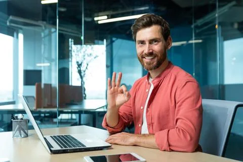 Portrait of a successful young man programmer, designer, freelancer in a red 스톡 사진