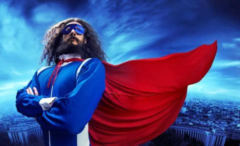 Portrait of a superheroe posing over the urban landscape Stock Photos