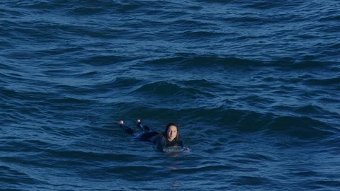 Portrait Of Surfer Relaxing Between Waves, Holds Up Peace Signs With Both Hands Stock-Footage 98671398