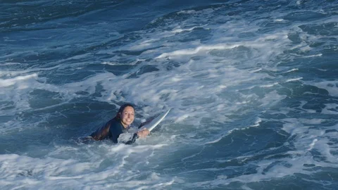 Portrait Of Surfer Smiling At Camera, Then She Paddles Out Toward Waves Stock Footage 98671617
