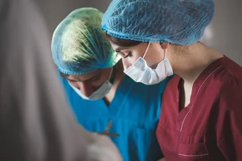 Portrait of surgeons at work, operating in uniform. Stock Photos