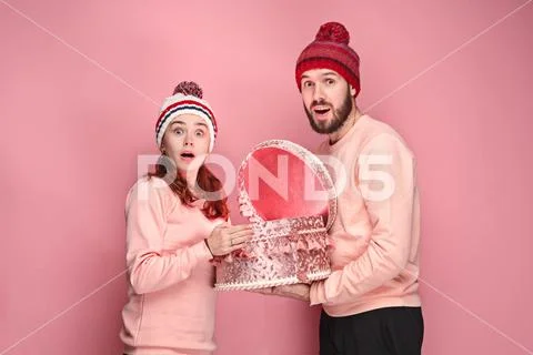 Portrait of a surprised little girl with her father holding a Christmas present Stock Photos