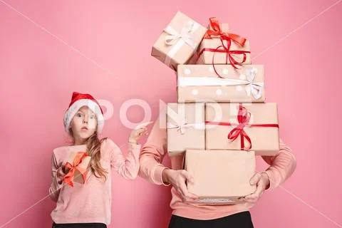 Portrait of a surprised little girl with her father holding a Christmas present Stock Photos