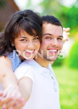 A portrait of a sweet couple in love embracing outdoors Stock-Fotos