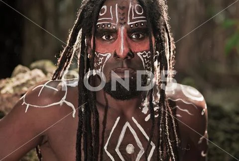 Portrait of the Taino Indian with dreadlocks and red body painting on his fac Stock Photos