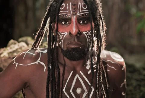 Portrait of the Taino Indian with dreadlocks and red body painting on his fac Stock Photos