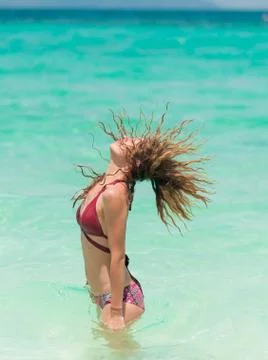 Portrait of tan model looking at seaside outdoors Stock Photos