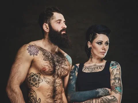 Portrait of tattooed man and woman at photo studio Stock Photos