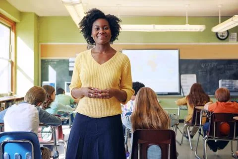Portrait, teacher and black woman with students learning in classroom. Education Stock Photos