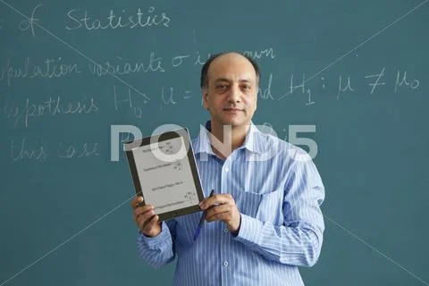 Portrait Of Teacher Holding Digital Tablet