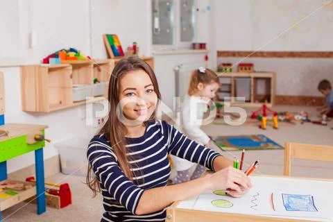 Portrait of teacher in a kindergarten Stock Photos
