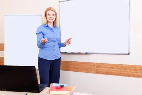 Portrait teacher woman femail classroom blue laptop notebook computer online  Stock Photos