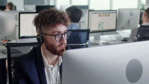Portrait of a Technical Customer Support Specialist Talking on a Headset while Stock Footage 168906462
