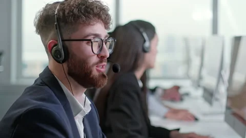 Portrait of a Technical Customer Support Specialist Talking on a Headset while Stock Footage 168970654