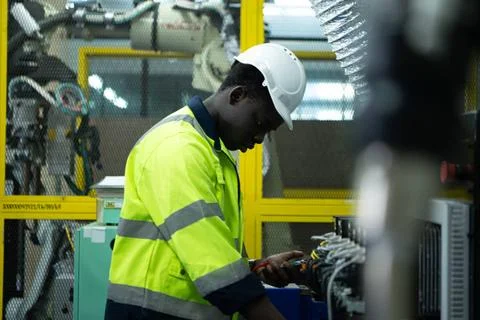 Portrait of a technician working with a digital multimeter to test the ele... 스톡 사진