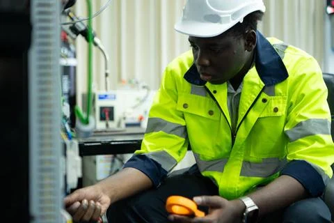 Portrait of a technician working with a digital multimeter to test the ele... 스톡 사진