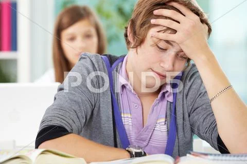 Portrait of teenage lad reading book during lesson Stock Photos