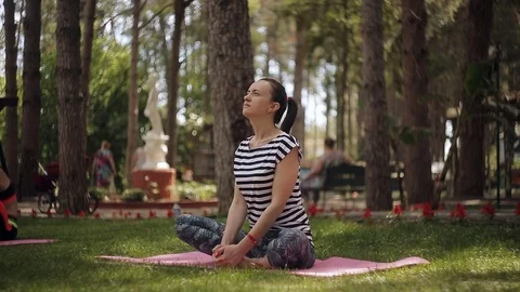 Portrait of thai adult beautiful girl doing yoga exercises in the park Stock Footage