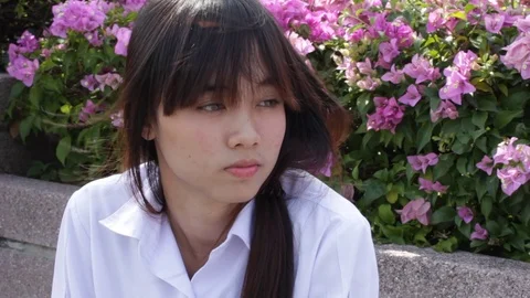 Portrait of thai high school student uniform teen beautiful girl using her phone Stock Footage 70608269