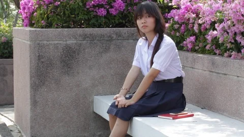 Portrait of thai high school student uniform teen beautiful girl using her phone Stock Footage 70608674
