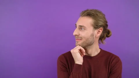 Portrait of a thinking man. long haired man isolated on purple background 4K Stock Footage 148827345