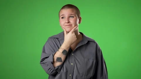 Portrait of thinking, smart puzzled pensive young non binary, gender fluid woman Stock Footage 223698226