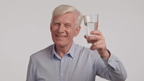 Portrait of thirsty gray haired senior man drinking clear water from glass. Stock Footage 263280183