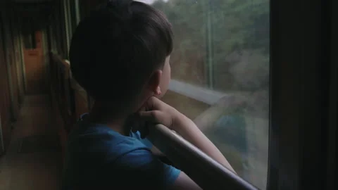 Portrait of thoughtful boy looking out the window of a leading train. Stock Footage 157704752