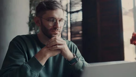 Portrait Of Thoughtful Man Looking At Laptop Display In Cafe, Businessman 動画素材 343669580