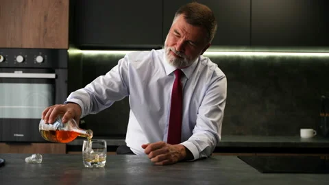 Portrait thoughtful senior man drinking whiskey in luxury interior Stock Footage 234649159
