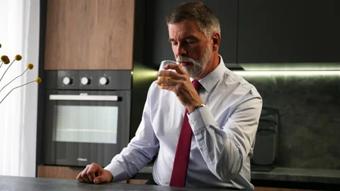 Portrait thoughtful senior man drinking whiskey in luxury interior Stock Footage 234650153