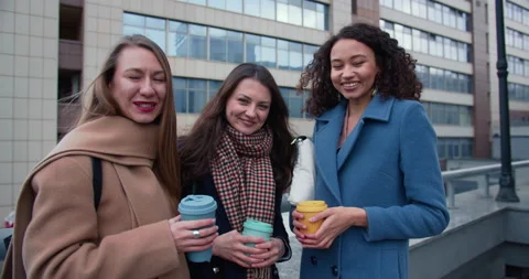 Portrait of three beautiful multiethnic young women friends posing with coffee Stock Footage 144207501
