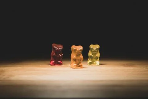 A portrait of three different colored gummi bears, the candy is standing on a Stock Photos
