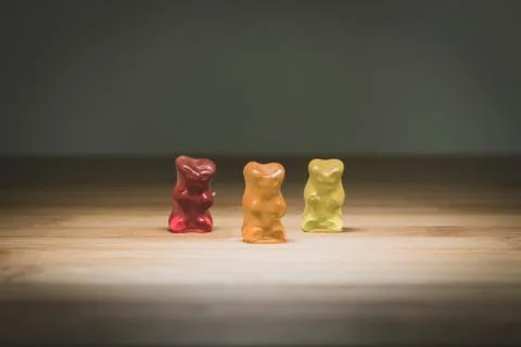 A portrait of three different colored gummi bears, the candy is standing on a Stock Photos