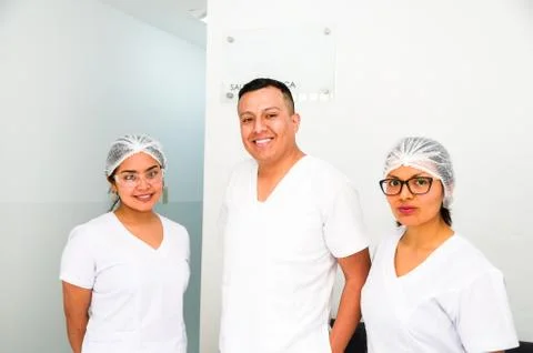 Portrait of three doctors smiling at the camera. Stock Photos